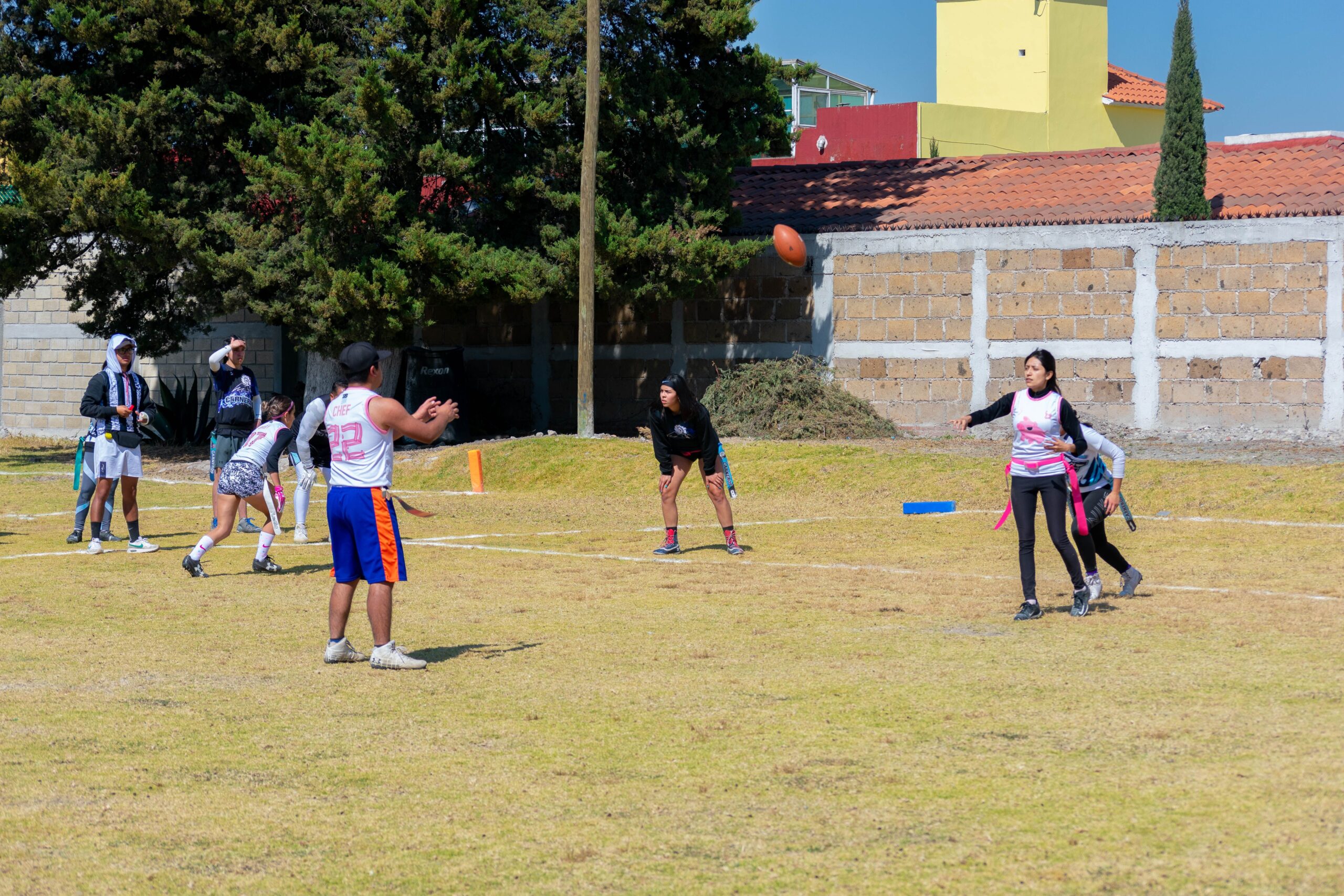 Jugada de flag football en partido juvenil